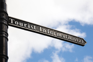 Fototapeta premium black and white tourist information sign with blue sunny skies in the background