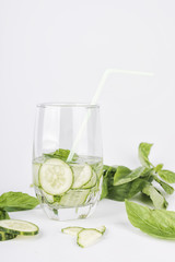 Glasses of cucumber detox water. Homemade cold gin tonic with basil isolated on the white background