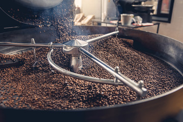 Aromatic coffee beans situating in modern equipment with grain chiller. Industry concept