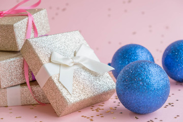 Gold gift box and a small Bell tied a red bo lay on the wood White and pine Christmas day