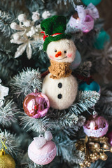 Knitted Chrismas toys on green fir branches