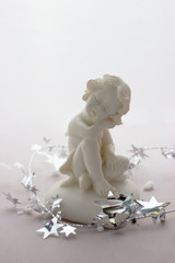 Figurine of a sleeping angel on a white background.