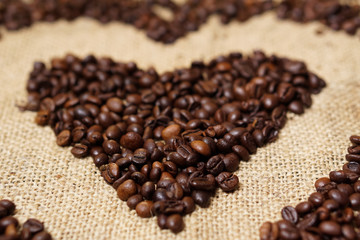 Love heart made of coffee beans on sackcloth
