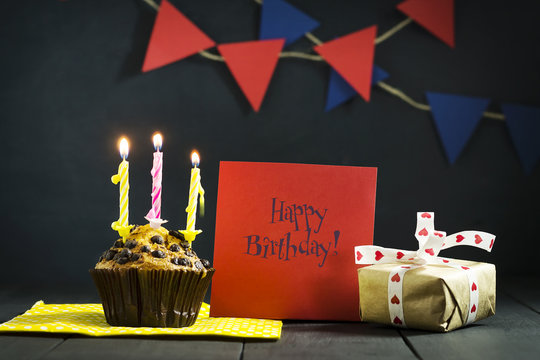 Birthday cupcake on a dark background. Happy Birthday. Postcard. Congratulations.
