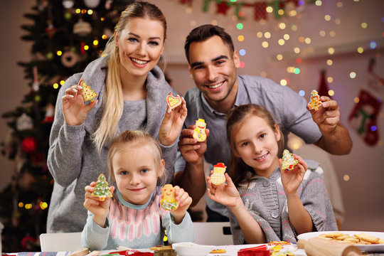 Happy family preparing Christmas biscuits