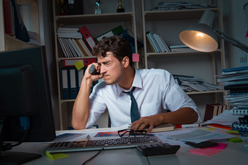 Man businessman working late hours in the office