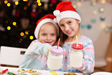 Happy little sisters preparing Christmas biscuits