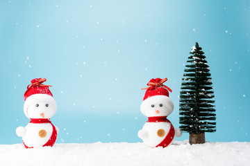 Christmas tree and snowman on snow