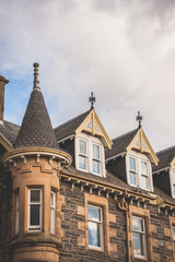 looking up to the rooftop windows of a typical old building in the town of grantown-on-spey in the scottish highlands