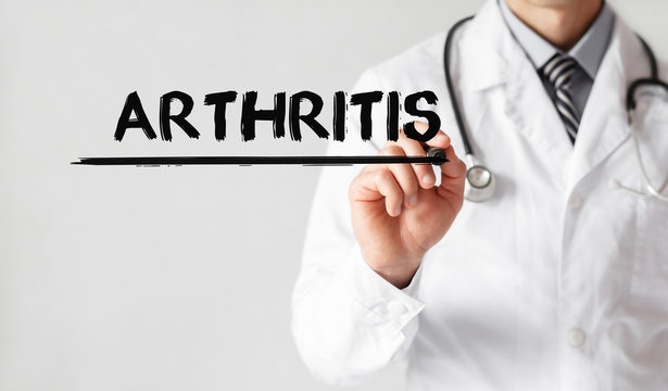 Doctor writing word Arthritis with marker, Medical concept
