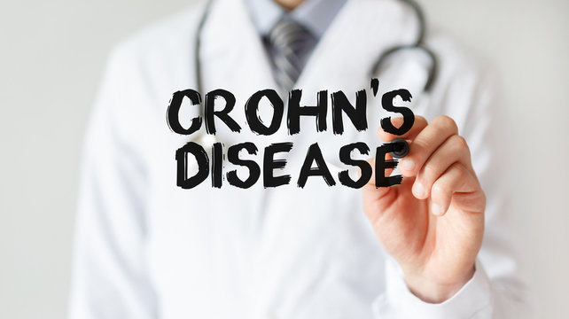 Doctor writing word Crohn's disease with marker, Medical concept