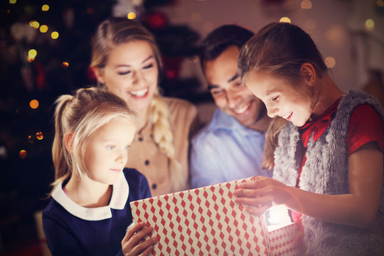 Happy Family Opening Christmas Present