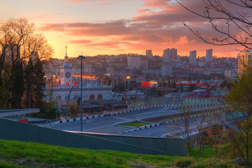 Aerial view of city and highway "Doubler of Kurortnyy Prospekt" at sunset, Sochi, Russia
