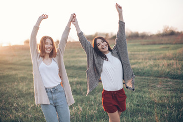 Two girls on sunset background. Best friends.