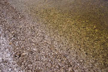 Pebbles ashore and clear water