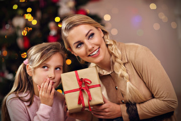 Happy family having fun with presents during Christmas time