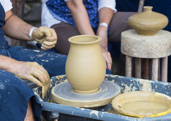 Potter making ceramic pot on the pottery wheel