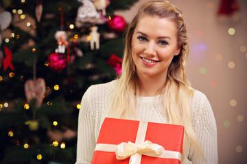 Happy woman posing with presents during Christmas time