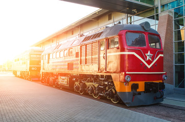 Diesel locomotive on the platform of the railway station.