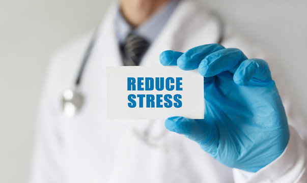 Doctor holding a card with text Reduce Stress,medical concept