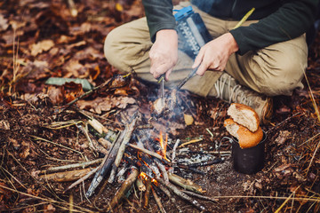 quail on the stick grilled in the fire. delicious forest picnic. bushcraft concept