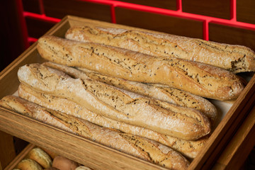 Fresh French baguettes bread in a wooden boxes in bakery