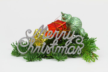 Silver Merry Christmas sign with fresh pine and miniature Christmas presents
