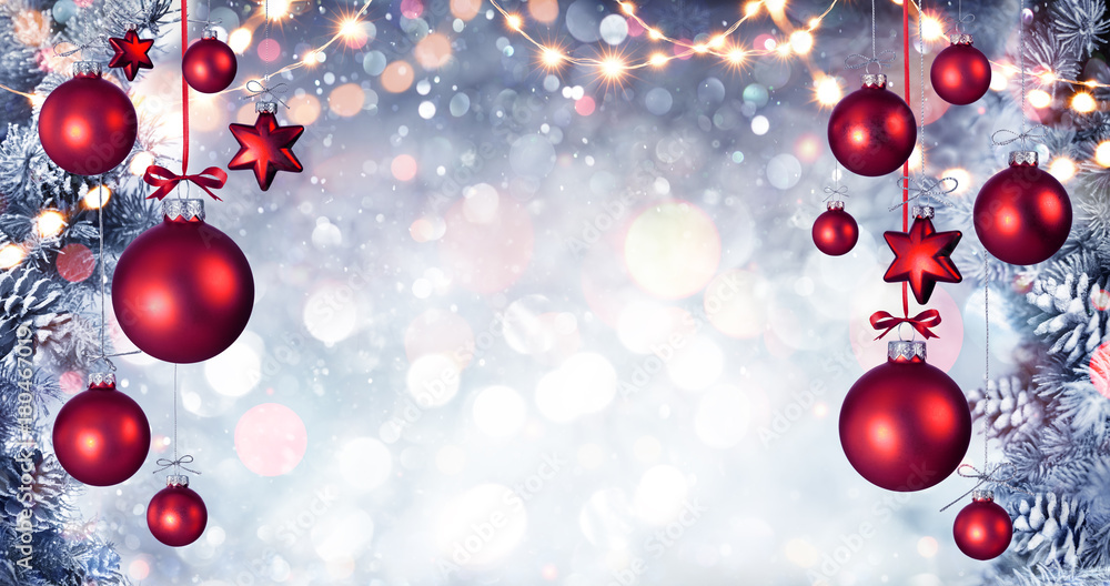 Canvas Prints red christmas balls hanging with snowy fir branches and string lights