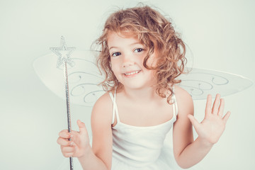 smilling  little girl with butterfly wings