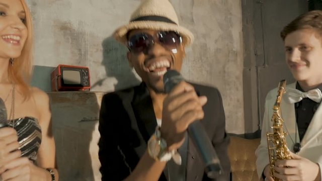 The African man is singing, close-up.
