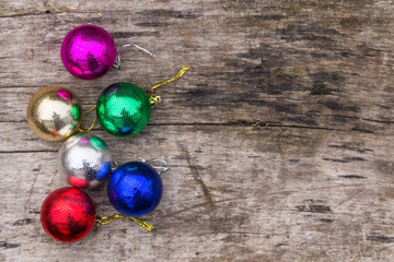Colored christmas decorations on rustic wooden table