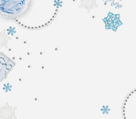 Christmas background with place for text. Blue snowflakes, shiny beads on white background. Place for text