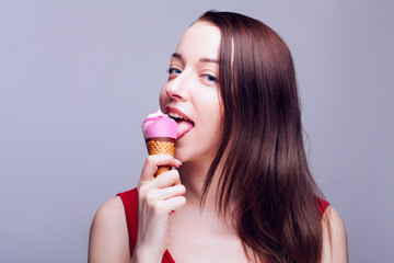 Young beautiful girl is eating ice cream. Isolated.