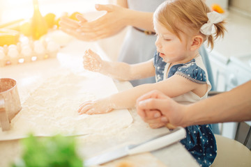 little cute girl is learning how to make a cake, in home kitchen, Family concept