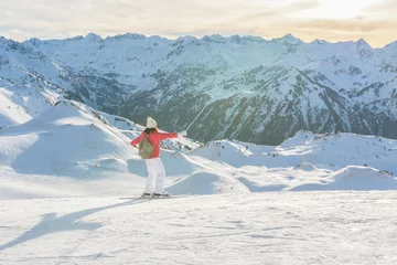 Fotobehang Happy skier woman enjoying the mountains view in the ski slopes © Fominayaphoto