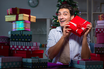 Man with many christmas gifts in boxes