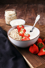 Bowl of homemade granola muesli with yogurt and fresh berries.