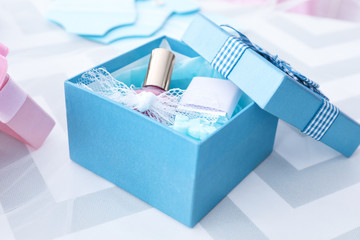 Box with baby shower favors on table