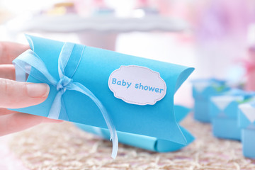 Woman holding box with baby shower favors
