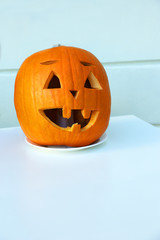 Pumpkin carved under a lamp