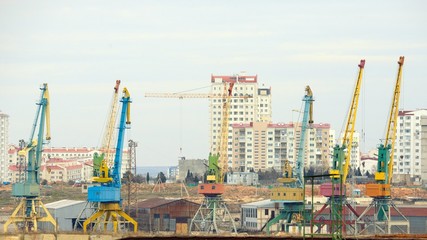 Fototapeta na wymiar Lot of cranes on a large building construction