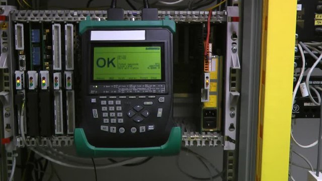 IT engineer test and maintenance telecom equipment in server room, datacenter.