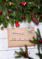 Christmas decoration on white wooden board Empty wishlist for Santa Claus laid on a wooden table