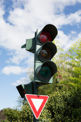 Traffic light with red color on blue sky background