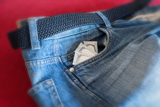 Condoms in the pocket of man's jeans
