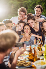 A group of students pose while a friend takes a picture