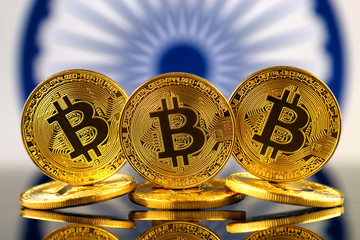 Physical version of Bitcoin (new virtual money) and India Flag. Conceptual image for investors in cryptocurrency and Blockchain Technology in India.