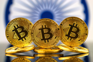 Physical version of Bitcoin (new virtual money) and India Flag. Conceptual image for investors in cryptocurrency and Blockchain Technology in India.