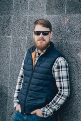 Handsome bearded man in casual clothes posing on camera