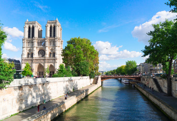 Notre Dame cathedral over the Seine river at sunny day, Paris, France